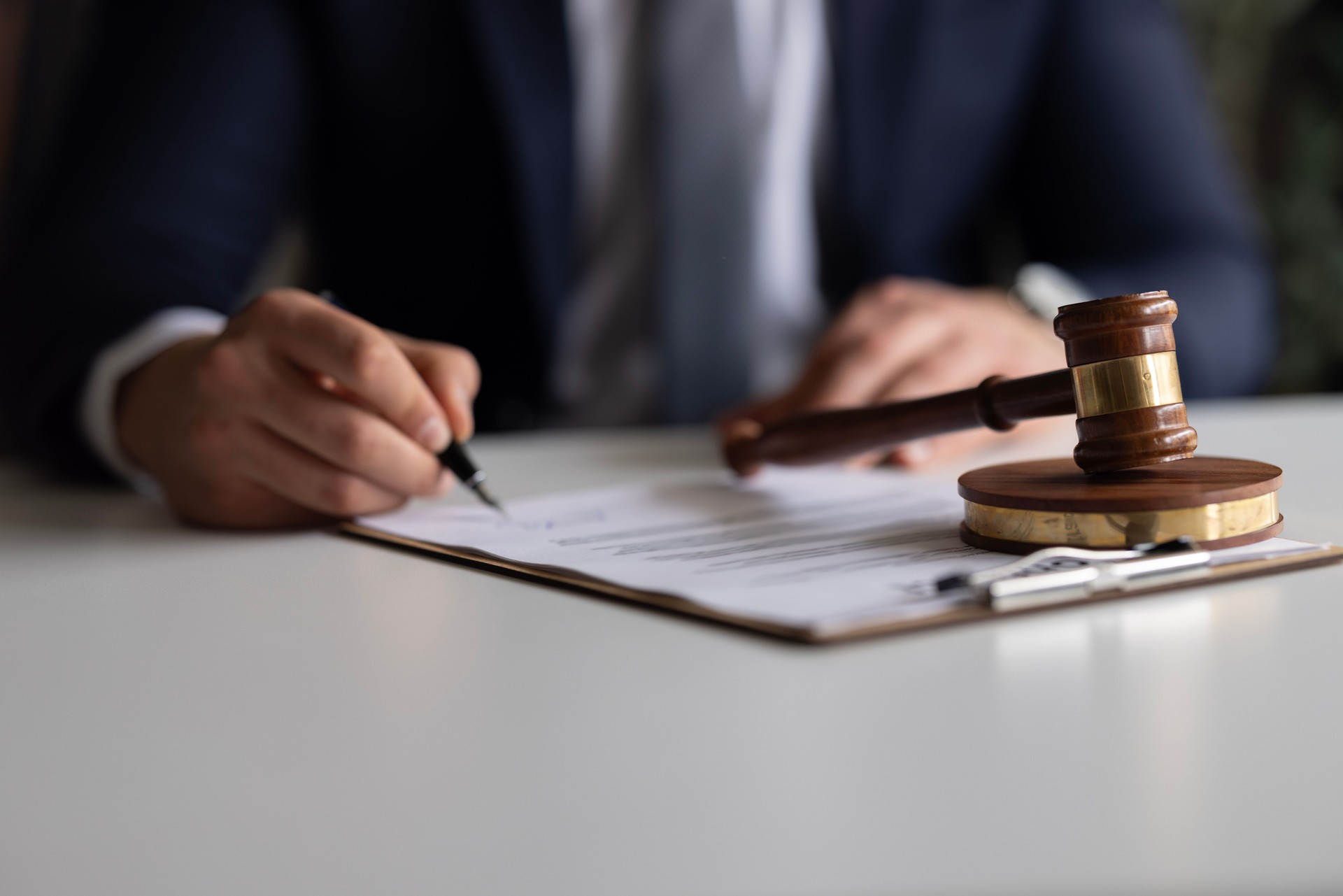 Judge or Legal advisor lawyer examining and signing legal documents.